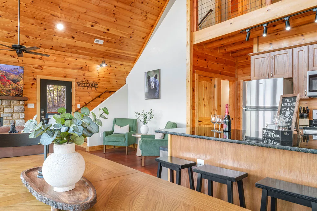 Dining table and kitchen bar seating in the cabin's open-plan main floor