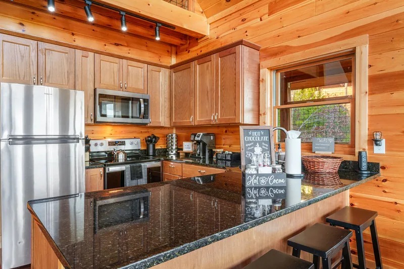 Kitchen island with granite counters and bar seating, open to the dining table